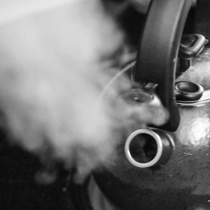 Photo of a kettle with steam.